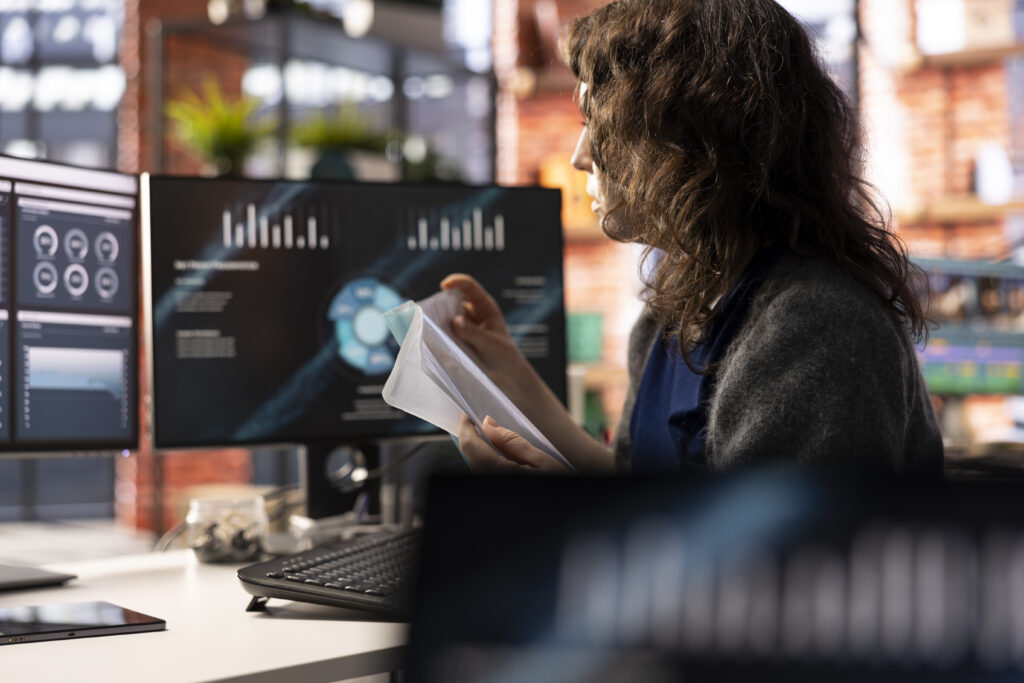 Remote worker at home watching business conference on PC monitor